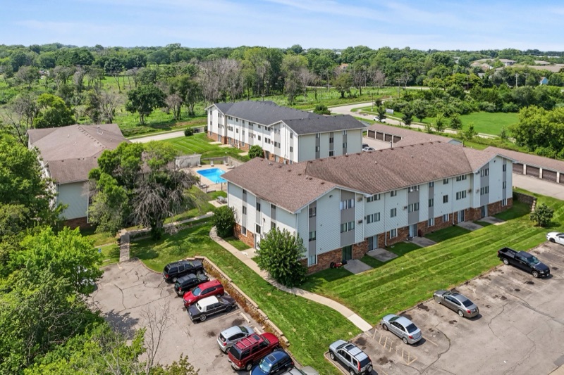 Aerial view of The Ridges community pool, buildings, and mature trees